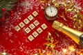 Red Christmas theme background with lettered wooden tiles forming the words Happy New Year