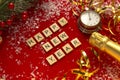 Red Christmas theme background with lettered wooden tiles forming the words Happy New Year