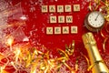 Red Christmas theme background with lettered wooden tiles forming the words Happy New Year