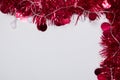 Red Christmas Tinsel and String Lights Border on White Background Royalty Free Stock Photo