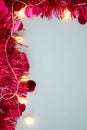 Red Christmas Tinsel and String Lights Border on White Background Royalty Free Stock Photo