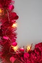 Red Christmas Tinsel and String Lights Border on White Background Royalty Free Stock Photo