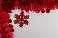 Red Christmas Tinsel and String Lights Border on White Background Royalty Free Stock Photo