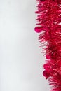 Red Christmas Tinsel and String Lights Border on White Background Royalty Free Stock Photo