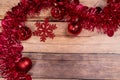 red christmas Tinsel and String Lights Border on wooden Background Royalty Free Stock Photo