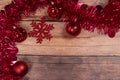 red christmas Tinsel and String Lights Border on wooden Background Royalty Free Stock Photo