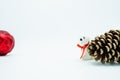 Red christmas tree bauble on white background with polar bear and pine cone. Royalty Free Stock Photo