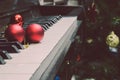 Red christmas tree decoration ball Put on the piano The background is decorated with Christmas decorations. Blurred Or New Year`s Royalty Free Stock Photo