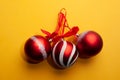 Red christmas tree decorations with a beautiful pattern on a yellow background Royalty Free Stock Photo