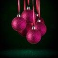 Christmas tree ornaments hanging. Balls made of glass or plastic hanging over abstract background Royalty Free Stock Photo