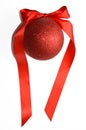 Red Christmas tree shiny ball with satin ribbon. Christmas toy. New year, Christmas. Decor. Red ball on white background. Royalty Free Stock Photo