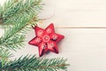 Red Christmas tree toy in the form of stars on a fir branch Royalty Free Stock Photo