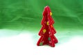 Red Christmas tree on a white to green canvas background