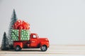 Red Christmas truck with pine tree and gift. Merry Christmas and happy new year concept Royalty Free Stock Photo