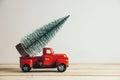 Red Christmas truck with pine tree and gift. Merry Christmas and happy new year concept Royalty Free Stock Photo