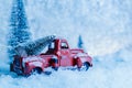 Red Christmas truck with pine tree on snow. Merry Christmas and happy new year concept Royalty Free Stock Photo