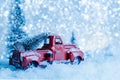 Red Christmas truck with pine tree on snow. Merry Christmas and happy new year concept Royalty Free Stock Photo