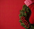 A Red Christmas Wallpaper With A Wreath And A Sock Royalty Free Stock Photo