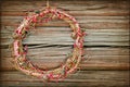 Red Christmas wreath on a wooden background Royalty Free Stock Photo