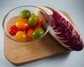 Red cicory and small tomatoes Royalty Free Stock Photo
