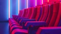 Red cinema seats with blue and purple neon lighting Royalty Free Stock Photo