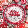 Red circle from decorative wands, with decorative Xmas plate and biscuits, cookies inside, snow effect, marble background