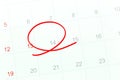 Red circle of the pen on the calendar paper shows the 14th