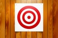 Red circle target hanging on wooden background