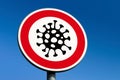 A red circle traffic sign trying to stop the corona virus SARS-CoV-2 and COVID-19 disease from spreading around