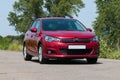 Red Citroen C4 on city road Royalty Free Stock Photo