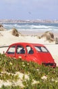 Red Citroen 2CV on a Beach