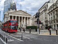 Red city bus by the Royal Exchange buliding in London, UK Royalty Free Stock Photo