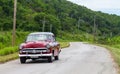 A red classic car drived on the road Royalty Free Stock Photo