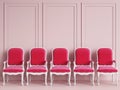 Red classic chairs are standing in an empty pink room with moldings on the wall Royalty Free Stock Photo