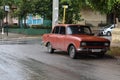 Red classic Cuban car parked on a street in Havana