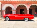 Red classic Cuban vintage car. American classic car on the road in Havana, Cuba.