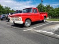 Red classic 1955 Ford F-100 Pickup Truck. Parked in a parking lot next to an apartment building Royalty Free Stock Photo