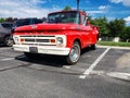 Red classic 1955 Ford F-100 Pickup Truck. Parked in a parking lot next to an apartment building Royalty Free Stock Photo