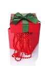 Red classic gift box with green satin bow and beads Royalty Free Stock Photo