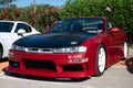 Red classic Japanese Nissan Silvia S14 Kouki sports car parked on the street