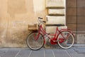 Red classic model women`s bicycle in the Italian city of Foligno