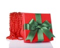 Red classic open gift box with green satin bow and beads Royalty Free Stock Photo