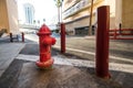 Red classic USA fire hydrant with protection on city street. Royalty Free Stock Photo