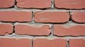 Red clay bricks are arranged in a staggered pattern, held together with gray mortar Royalty Free Stock Photo