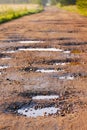 Red clay road with holes