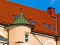 clay tile sloped roof. brick chimney and copper turret roof. stucco exterior facade Royalty Free Stock Photo