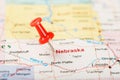 Red clerical needle on a map of USA, Nebraska and the capital Lincoln. Close up map of Nebraska with red tack Royalty Free Stock Photo