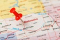 Red clerical needle on a map of USA, Nebraska and the capital Lincoln. Close up map of Nebraska with red tack Royalty Free Stock Photo