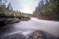 Red cliff, stone wall, forest, waterfall and wild river view in autumn Royalty Free Stock Photo