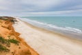 Red cliffs, beach and ocean